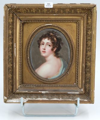 portrait of a young woman in a blue dress by a gold frame