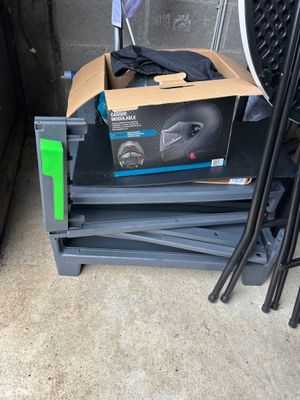 a box with a pair of shoes on top of a stack of chairs