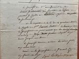 an old document with writing on it sitting on top of a table