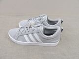 grey and white adidas sneakers with white laces on the sole