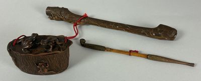 two wooden sticks and a wooden bucket on a table