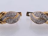 a pair of gold and diamond earrings