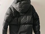 a black jacket hanging on a hook on a wall