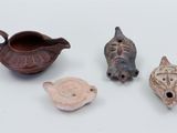 several different types of pottery items are displayed on a white surface