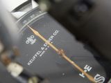 a close up view of a watch with a black face