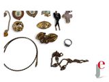 a lot of jewelry that is laying out on a white surface