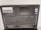 a laptop with a keyboard on a stand on a table