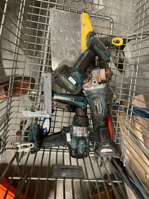 a wire basket with tools in it on the floor