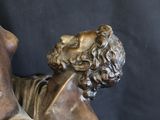a bronze statue of a man holding a dog