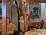 four wooden chairs that are sitting next to each other
