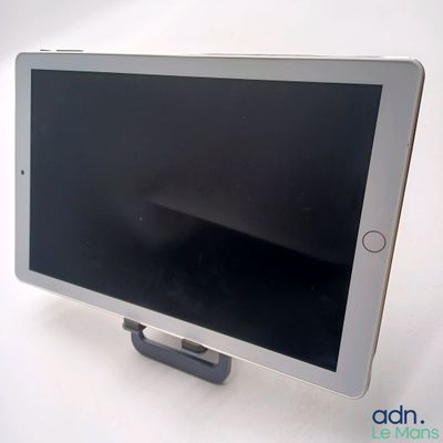 a tablet that is sitting on a stand on a table