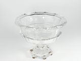 a clear glass bowl sitting on top of a wooden stand