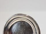 an image of a close up of a silver plate on a table