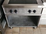 tiled floor in a kitchen with a stove and a sink