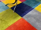 a multicolored rug on the floor in a room