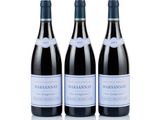 three bottles of wine sit on a white surface