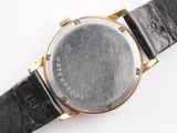 an image of a close up of a wrist watch on a white surface