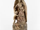 a statue of an angel holding a child on a rock