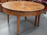 une table ronde avec un plateau en bois au milieu d'une pièce