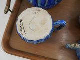a tray with blue and white pottery items on it