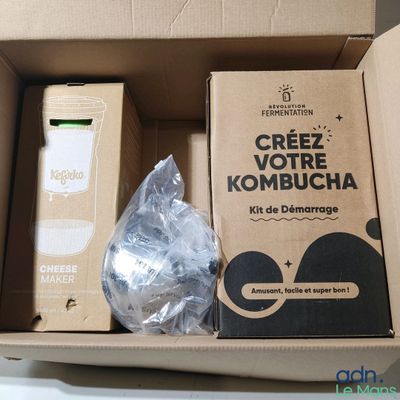 a cardboard box with a package of items inside of it