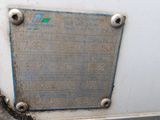 a metal plaque on the side of a white refrigerator