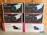 three boxes of cameras are stacked on top of each other