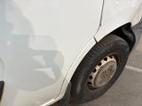 a white truck with a flat tire parked in a parking lot