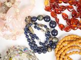 a lot of different colored beads on a white surface