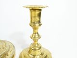 pair of antique brass candlesticks on a white background