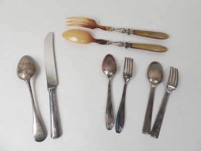 four forks, a spoon, and a knife on a table