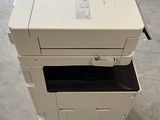 a white printer sitting on top of a stack of boxes