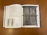 a book open on a table with a drawing of a cabinet