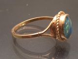 a gold ring with a blue stone in it