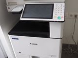 a printer that is sitting on top of a cabinet