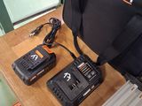 a black bag and two batteries on a wooden table