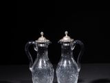 two clear glass vases sitting on top of a black table