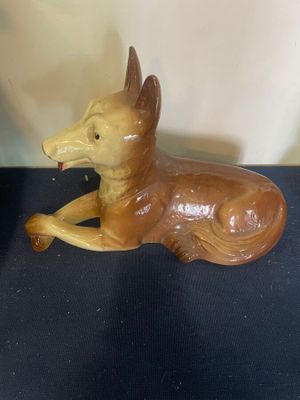 a figurine of a dog laying down on a table
