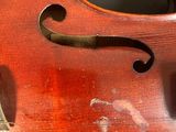 a close up of a violin that is on a table