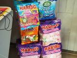 many bags of candy stacked on top of each other