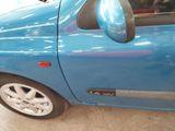 a blue car with a mirror on the side of it