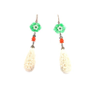 pair of earrings with green and white beads and a flower