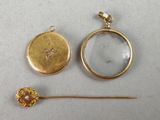 a close up of a gold locke with a flower and a magnifying glass