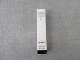 a close up of a tube of chanel lipstick on a gray surface