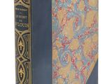un vieux livre avec une couverture bleue et une couverture jaune et bleue