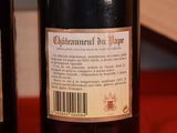 two bottles of wine on a table with a red cloth