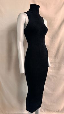 the mannequin is wearing a black dress with a turtle neck