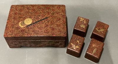 a wooden box with four pieces of dice on it