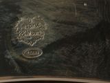 a close up of a silver plate with a picture on it