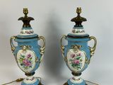 pair of blue and white vases with flowers on them
